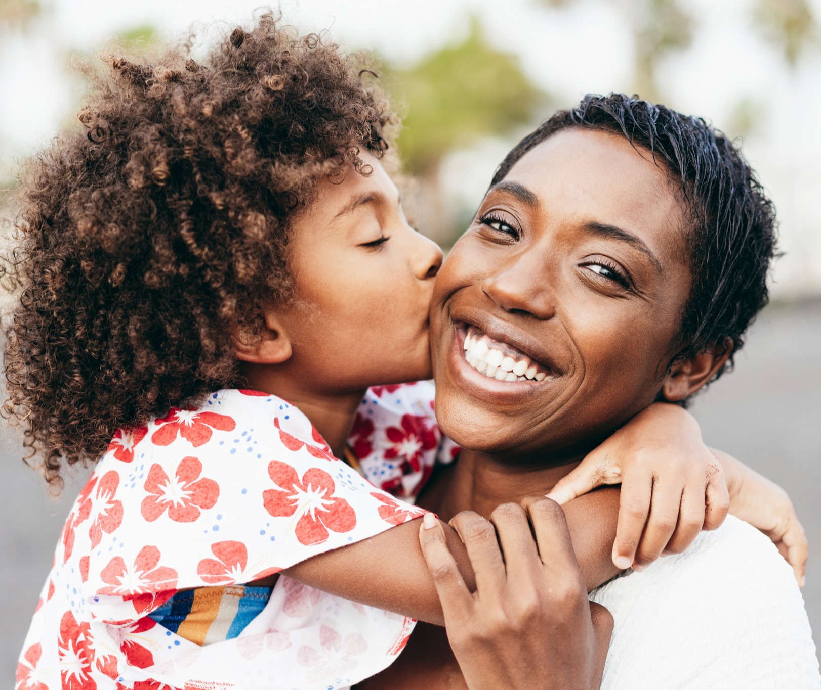 Child kissing happy mother